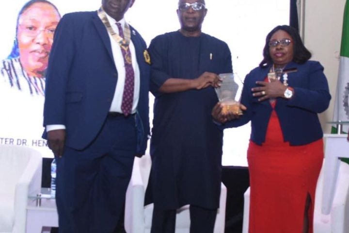 the representative of the late Rev Sr Dr Henrietta Alokha Barrister Anselm Alokha in the middle showing the award. Flanked by the District Governor Rotary Club International District 9110,Mrs Omotunde Lawson at the event