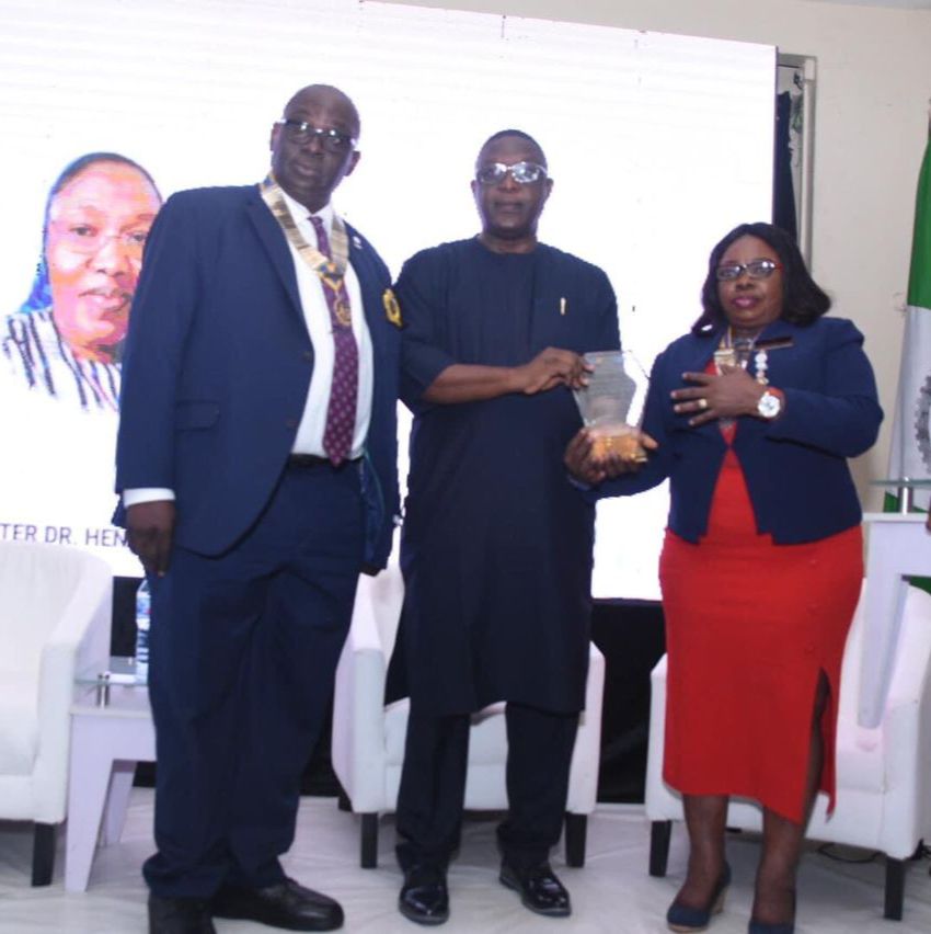 the representative of the late Rev Sr Dr Henrietta Alokha Barrister Anselm Alokha in the middle showing the award. Flanked by the District Governor Rotary Club International District 9110,Mrs Omotunde Lawson at the event