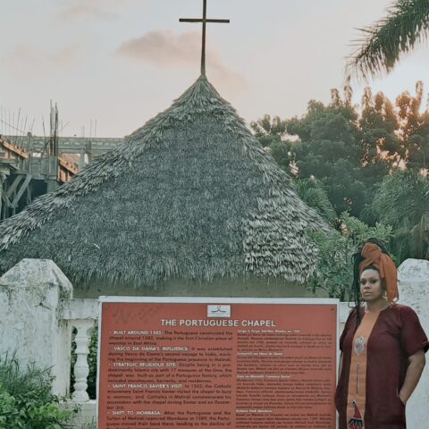 Photo Caption: Kim Poole, Founder of the Teaching Artist Institute, stands at the Portuguese Chapel in Malindi, Kenya, built in 1502 and recognized as the first Christian place of worship in East Africa. The chapel remains a testament to the region’s layered history of colonial expansion